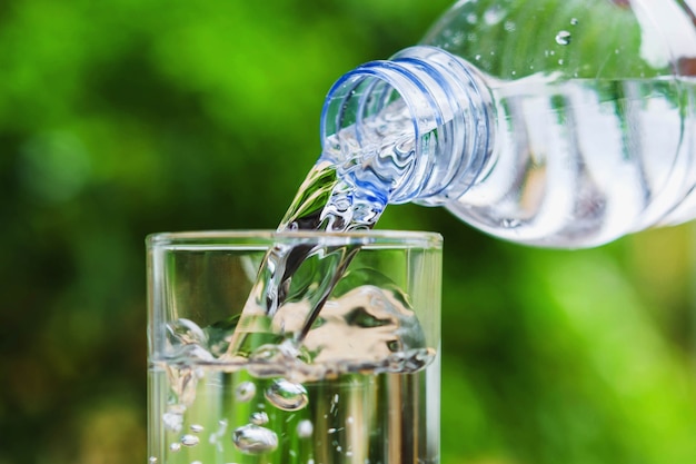 Premium Photo | Drinking water poured into the glass and sunlight ...