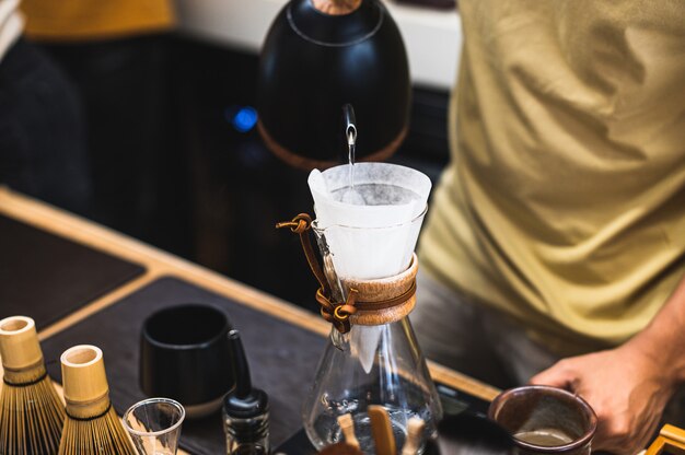 Drip brewing, filtered coffee, or pour-over is a method which involves pouring water over roasted, ground coffee beans contained in a filter Premium Photo