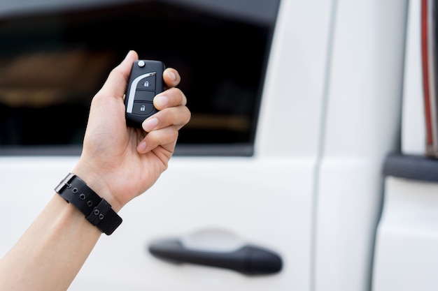 Driver man hand holding keyless of autonomous car for unlock via wireless technology Premium Photo