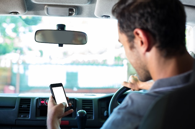 Premium Photo | Driver using phone in car