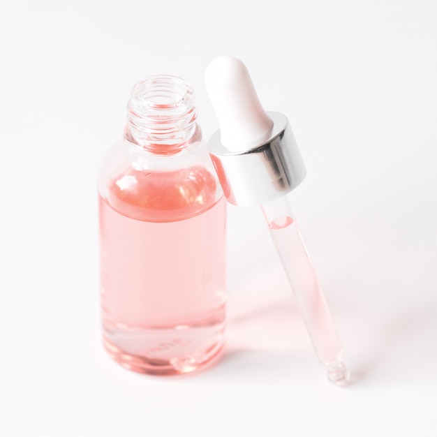 Download Premium Photo Dropper Bottle With A Pipette And Pink Water