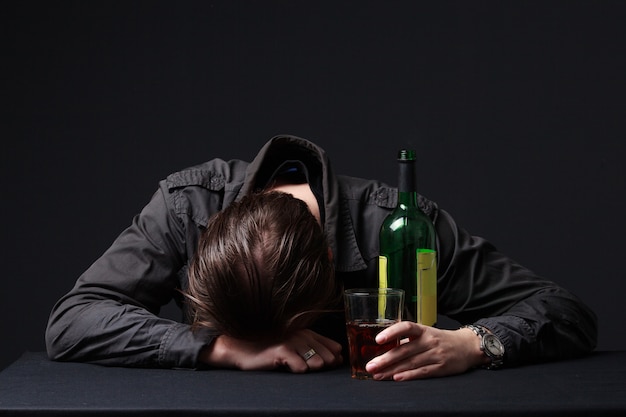 Premium Photo | Drunk man sleeping on the table with a wineglass in the hand