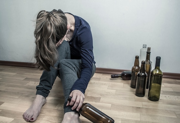 Premium Photo A Drunk Woman With A Bottle Of Wine Depressive Girl