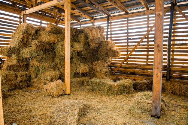 Premium Photo | Dry hay stacks in rural wooden barn interior