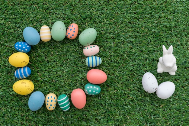 Free Photo | Easter composition with circle of eggs and decorative rabbit