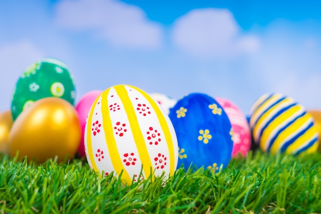 Free Photo | Easter eggs on fresh green grass over blue sky