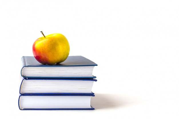 Education or back to school . an appleon a stack of books isolated on a white with copyspace. Premium Photo