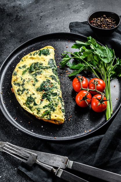 Premium Photo | Egg omelet with spinach, served on a plate with tomatoes.