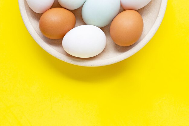 premium-photo-eggs-on-yellow