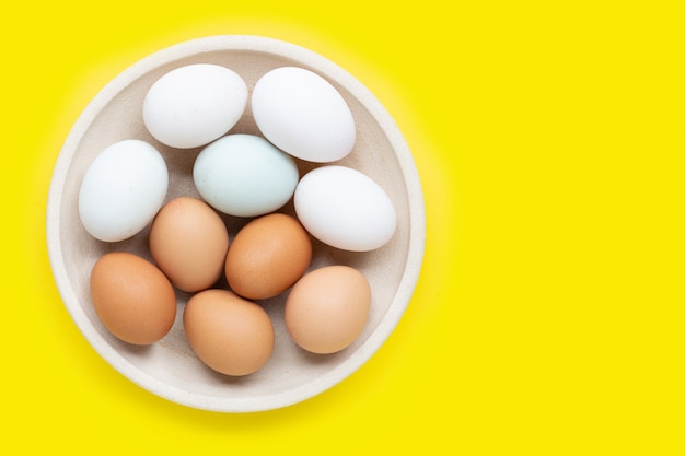 premium-photo-eggs-on-yellow