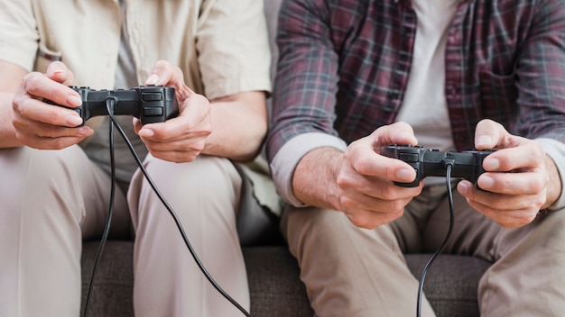 Elder couple playing video games together Free Photo