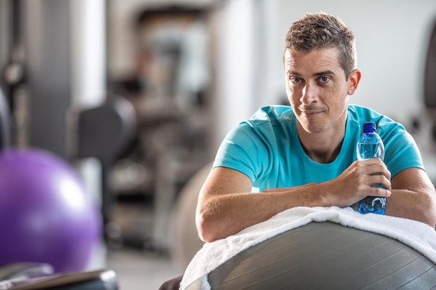 Premium Photo Elderly Man Resting On An Exercise Ball In The Gym