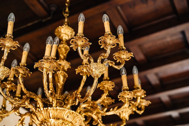  Electric chandelier with bulbs antique golden chandelier in the interior of an old villa