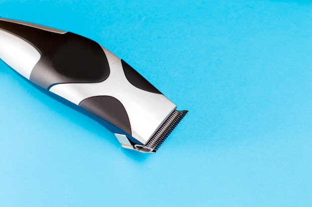 Premium Photo | Electric clipper on blue