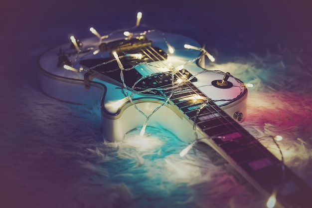 Premium Photo | Electric guitar with lighted garland. new year gift in ...