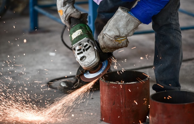 Premium Photo | Electric wheel grinding on steel pipe in factory