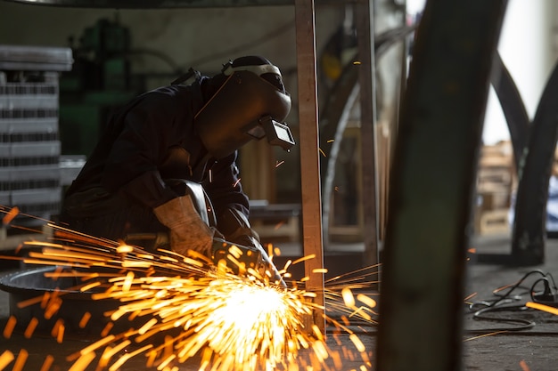 Premium Photo | Electric Wheel Grinding On Steel Structure And Welders ...