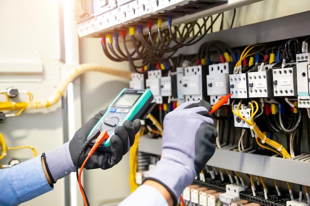 Premium Photo | Electrical engineer using digital multi-meter measuring ...