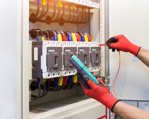 Premium Photo | Electrical engineers check electrical control devices ...