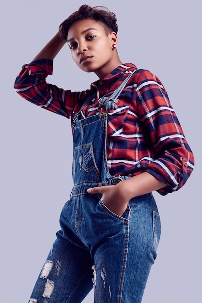 Elegant Black Hipster Girl With Short Hair In A Plaid Shirt And