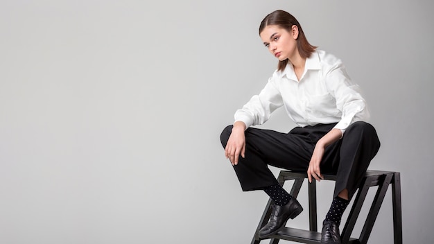 Elegant female model posing in stairs in a jacket suit. new feminity concept Free Photo