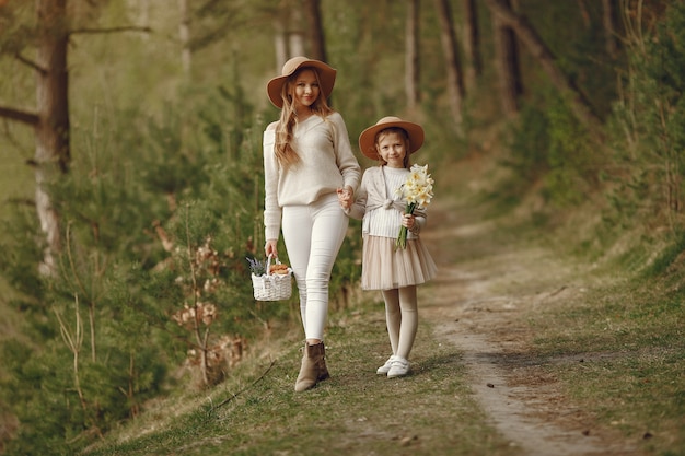 Elegant mother with daughter in a summer forest Free Photo