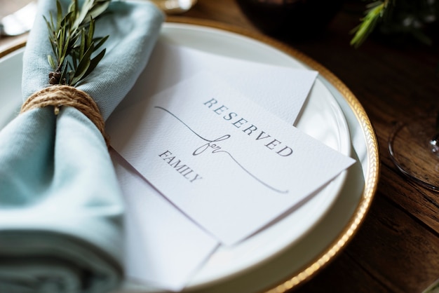 Elegant restaurant table setting service for reception with reserved card Premium Photo