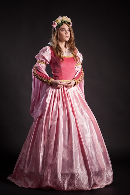 Premium Photo | Elegant woman in medieval era dress on dark background