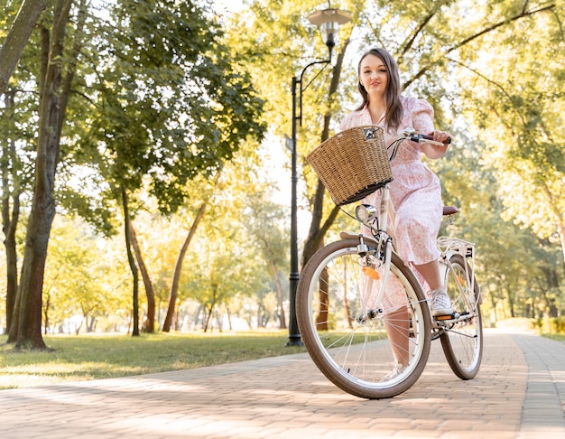 Free Photo | Elegant young woman riding bicycle