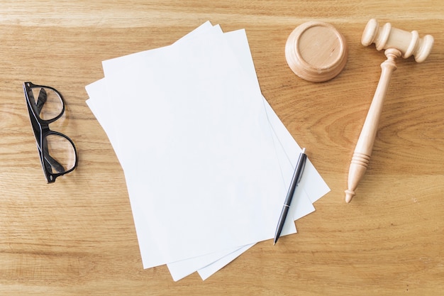 Elevated View Of Blank Papers Spectacles Pen And Wooden Gavel On