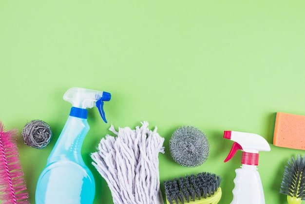 Free Photo | Elevated view of cleaning supplies on green backdrop