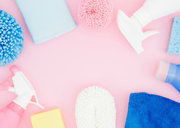 An elevated view of cleaning supplies on pink backdrop Photo | Free ...