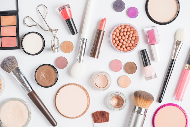 Free Photo | Elevated View Of Makeup Kit With Brushes On Pink Background