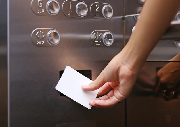 Premium Photo | Elevator access control, hand holding a key card to ...