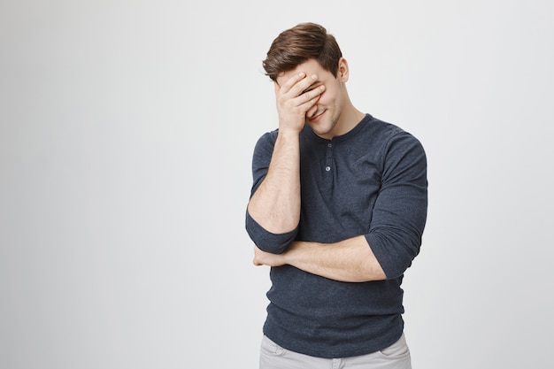 Free Photo Embarrassed Man Facepalm And Smiling