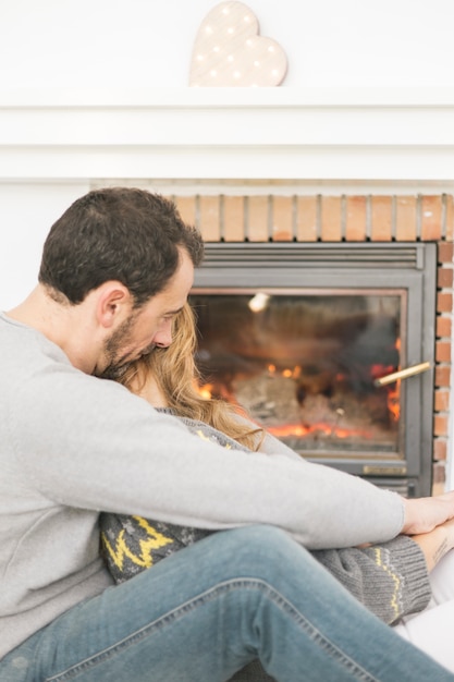 Free Photo Embracing Couple Cuddling At Fireplace.