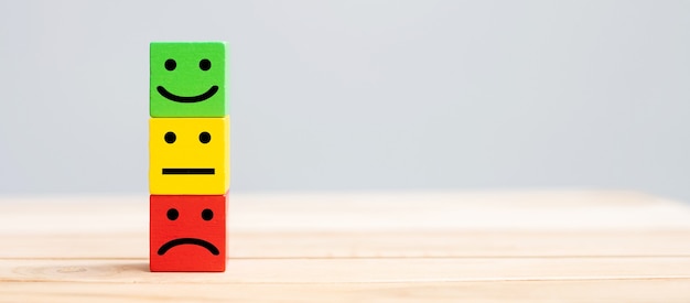 Premium Photo | Emotion face symbol on wooden blocks