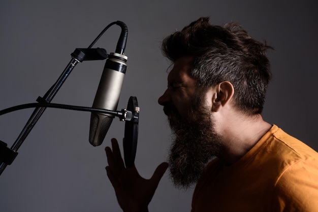 Premium Photo | Emotional bearded man screaming in microphone music ...