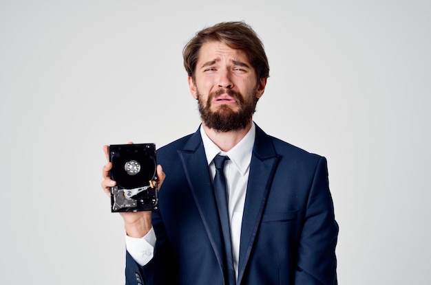 Emotional business man with hard drive on computer technology Premium Photo