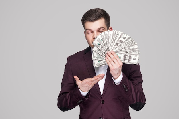 Premium Photo | Emotional young man in suit on gray background