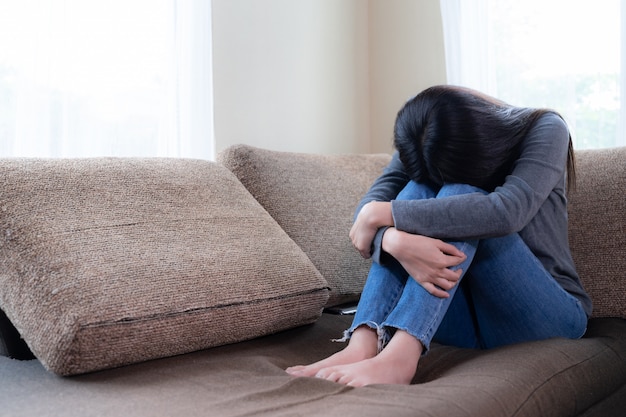 Emotional young woman was depressed on sofa Free Photo