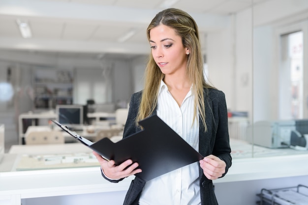 Employee reading a report Photo | Free Download