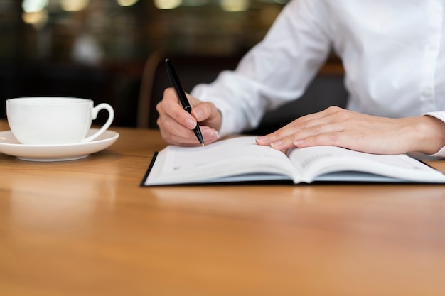 Free Photo | Employee writing in agenda front view