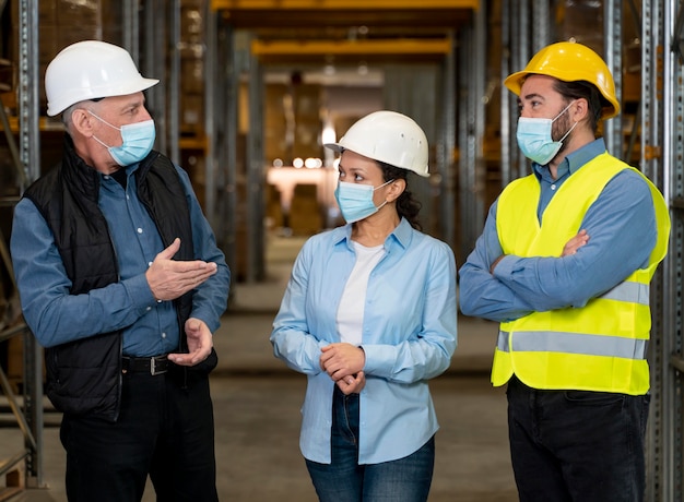 Free Photo | Employees with masks working in warehouse