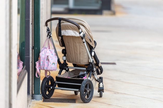 Premium Photo | Empty baby stroller near the store on the street