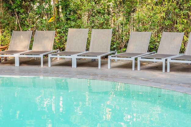 Empty Chair Around Swimming Pool In Hotel Resort Photo