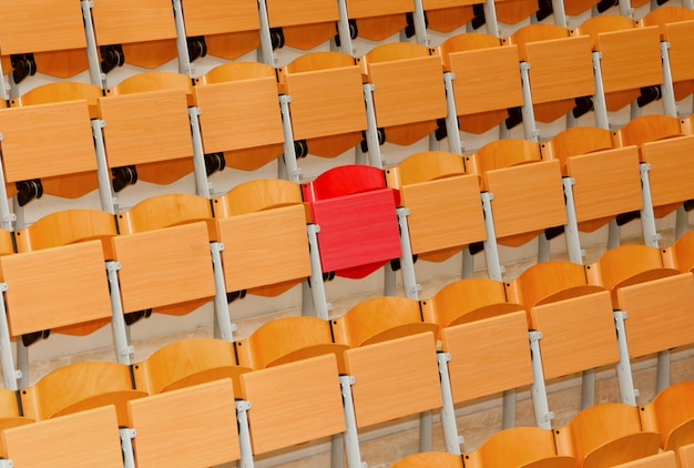 Premium Photo | Empty classroom with wood chairs and one red chair