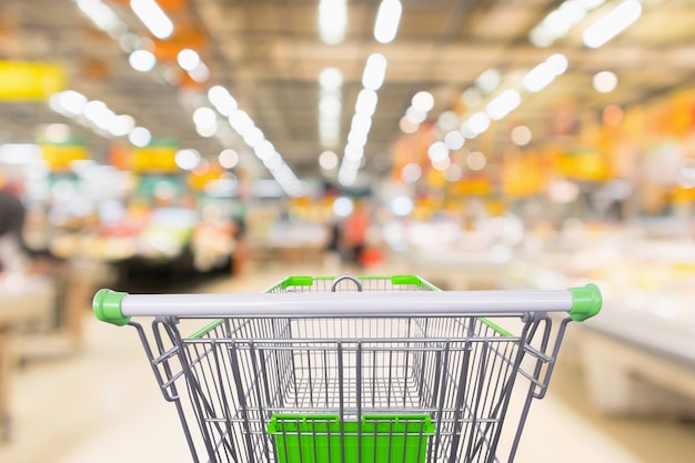 Premium Photo | Empty green shopping cart with blur supermarket