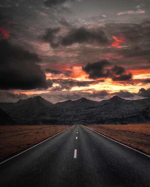 Premium Photo Empty Highway Overlooking Mountain Under Dark Sky