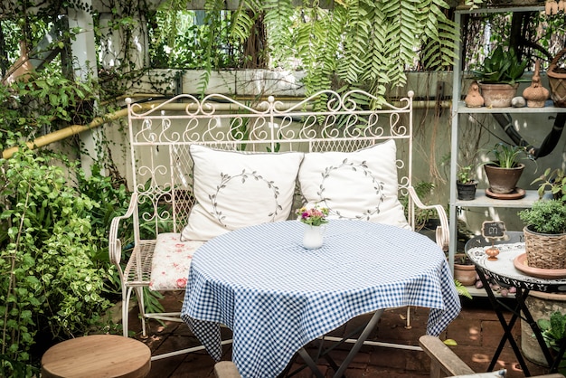 Empty outdoor patio table and chair decoration in garden Premium Photo